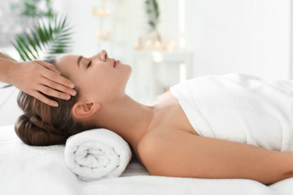 Relax and Rejuvenate at Spa Chevy Chase – Your Complete Guide Woman receiving relaxing head massage at a luxury Spa Chevy Chase location.