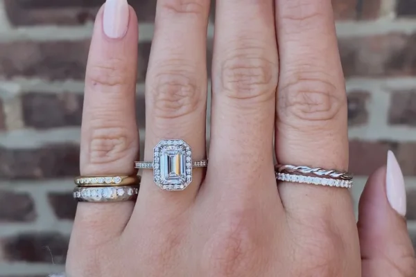 Emerald cut engagement rings with delicate halo enhancements emerald cut moissanite ring